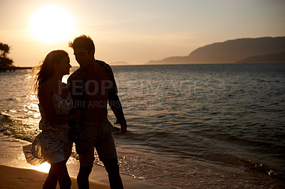 Buy stock photo Sunset, couple walk on beach and travel for anniversary or date with bonding, love and support. Calm, ocean peace and fresh air in nature, people outdoor and wellness, trust and care in relationship