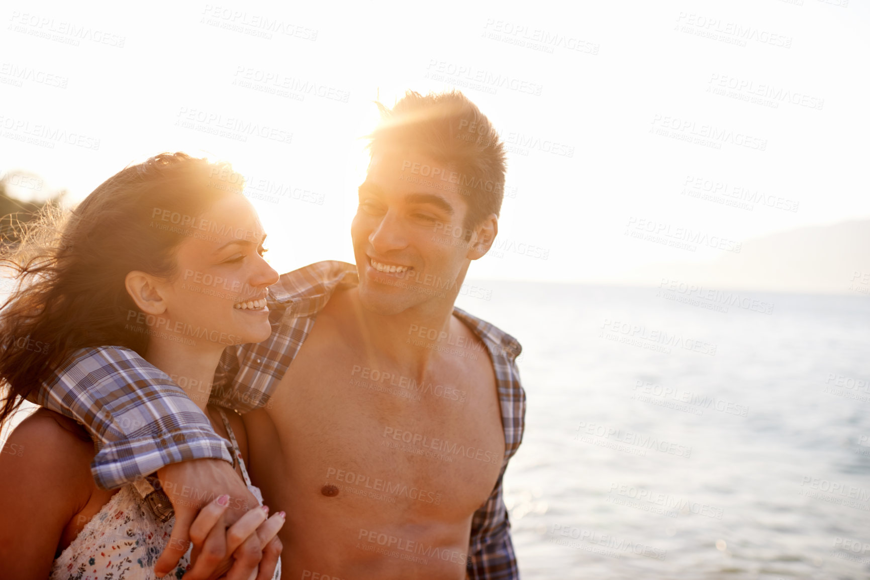 Buy stock photo Beach, happy and couple with vacation, sunshine and weekend break for honeymoon, travel and adventure. Hug, seaside and embrace with man, smile and woman with holiday and love with journey and summer