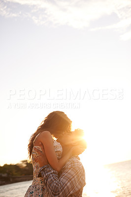 Buy stock photo Couple, kiss at beach and travel with sunset, ocean and vacation in Cancun for date or anniversary for love. Affection, bonding and hug with people on adventure together, commitment and trust outdoor