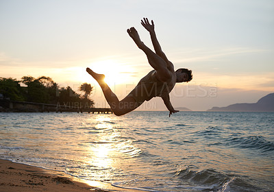 Buy stock photo Man, dancer and breakdance with jump on beach for hip hop performance, workout training and practice. Ocean, dancing and movement with energy at sunset, stunt or flexible talent on Maldives holiday