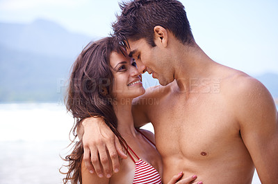 Buy stock photo Shot of a young couple enjoying a beach getaway