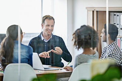 Buy stock photo Cropped shot of four young designers having a business meeting