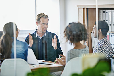 Buy stock photo Cropped shot of four young designers having a business meeting