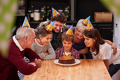 Buy stock photo Family, birthday cake and candle with kid, parents and grandparents together with cake and wish. Happy, smile and dessert with children and celebration with event food and party hats at a table