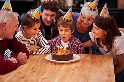 Buy stock photo Family, birthday cake and candle blow with kid, parents and grandparents together with wish. Happy, smile and dessert with children and celebration with food and party hats at a table ready to eat