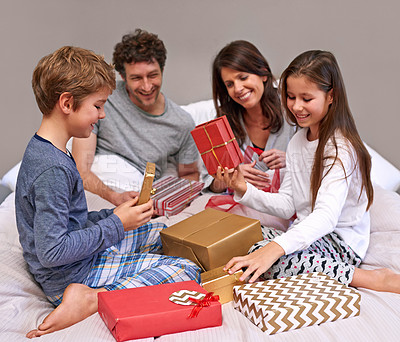 Buy stock photo Shot of a happy family of four in the bedroom