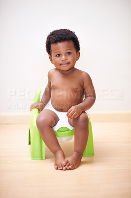 Buy stock photo African baby boy, potty training or toilet in home with youth, learning and childhood development on floor. Young toddler, black child or kid sitting in bathroom with diaper, growth and plastic seat