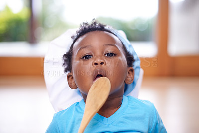 Buy stock photo Shot of an adorable baby boy licking a wooden spoon