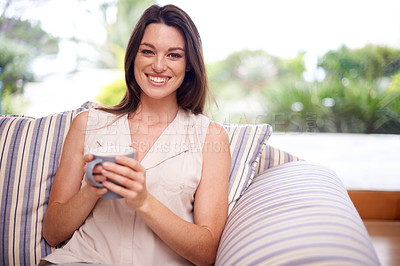 Buy stock photo Woman, home and happy in couch with coffee to relax or chill on break, day off and enjoy. Portrait, female person and smile in living room on sofa with cup of tea for peace and calm in lounge.
