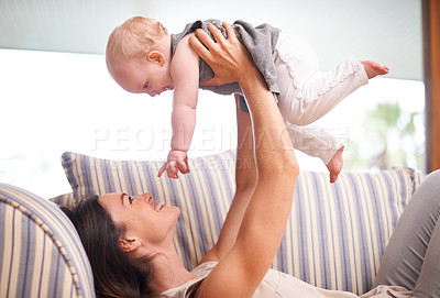 Buy stock photo Playing, happy and mother with baby on couch for laughing games, fun and bonding in living room together. Family, smile and mom with girl toddler sofa for love, childcare and parenting in apartment