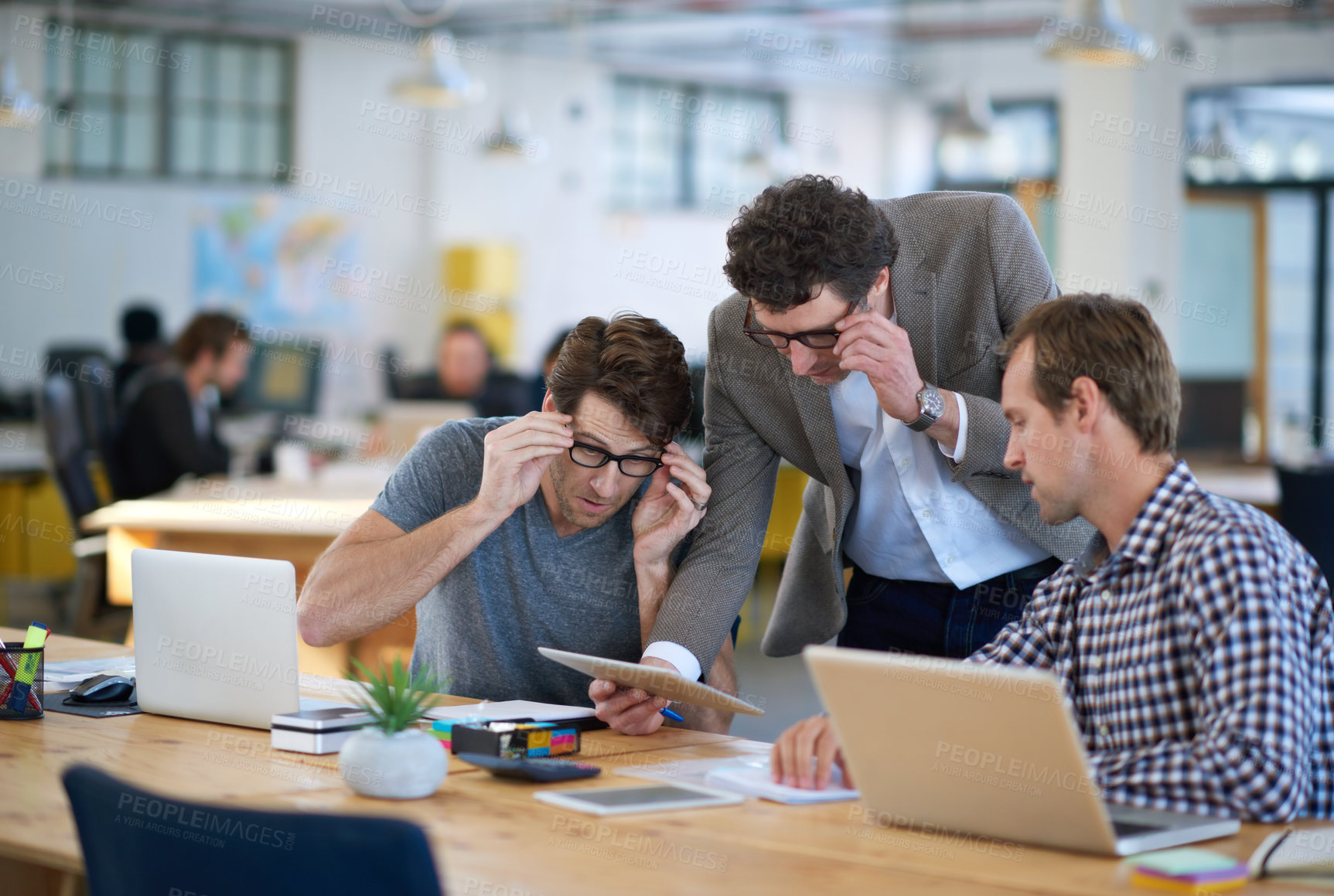 Buy stock photo Businessmen, tablet and talking for teamwork, communication and corporate planning together at office. Thinking, colleagues and tech for company startup, brainstorming or collaboration in workplace