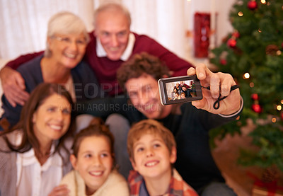 Buy stock photo Happy, family, camera and selfie in living room for christmas, bonding and relax in their home together. Happy family, photography and generations embrace and pose for festive picture, happy and joy