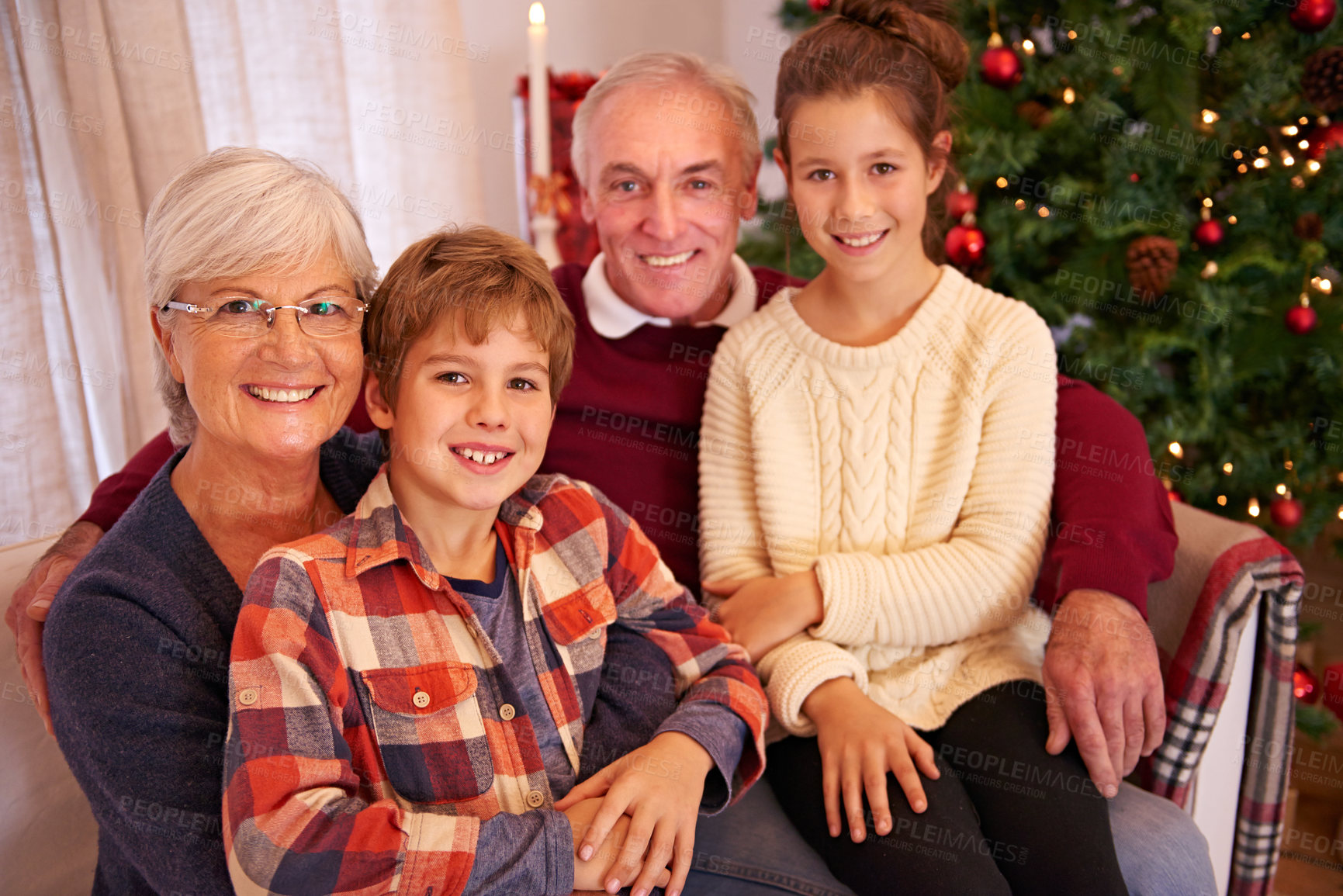 Buy stock photo Christmas, senior couple and couch with grandchildren, happiness and relax for festive season at home. Xmas, love and elderly man with mature woman, grandkids or happy with smile, content or portrait