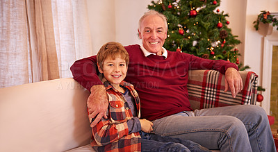 Buy stock photo Christmas, happy and grandfather with a boy on a sofa in the living room of family home. Happiness, smile and senior man in retirement relaxing with grandchild in lounge with festive xmas decoration.