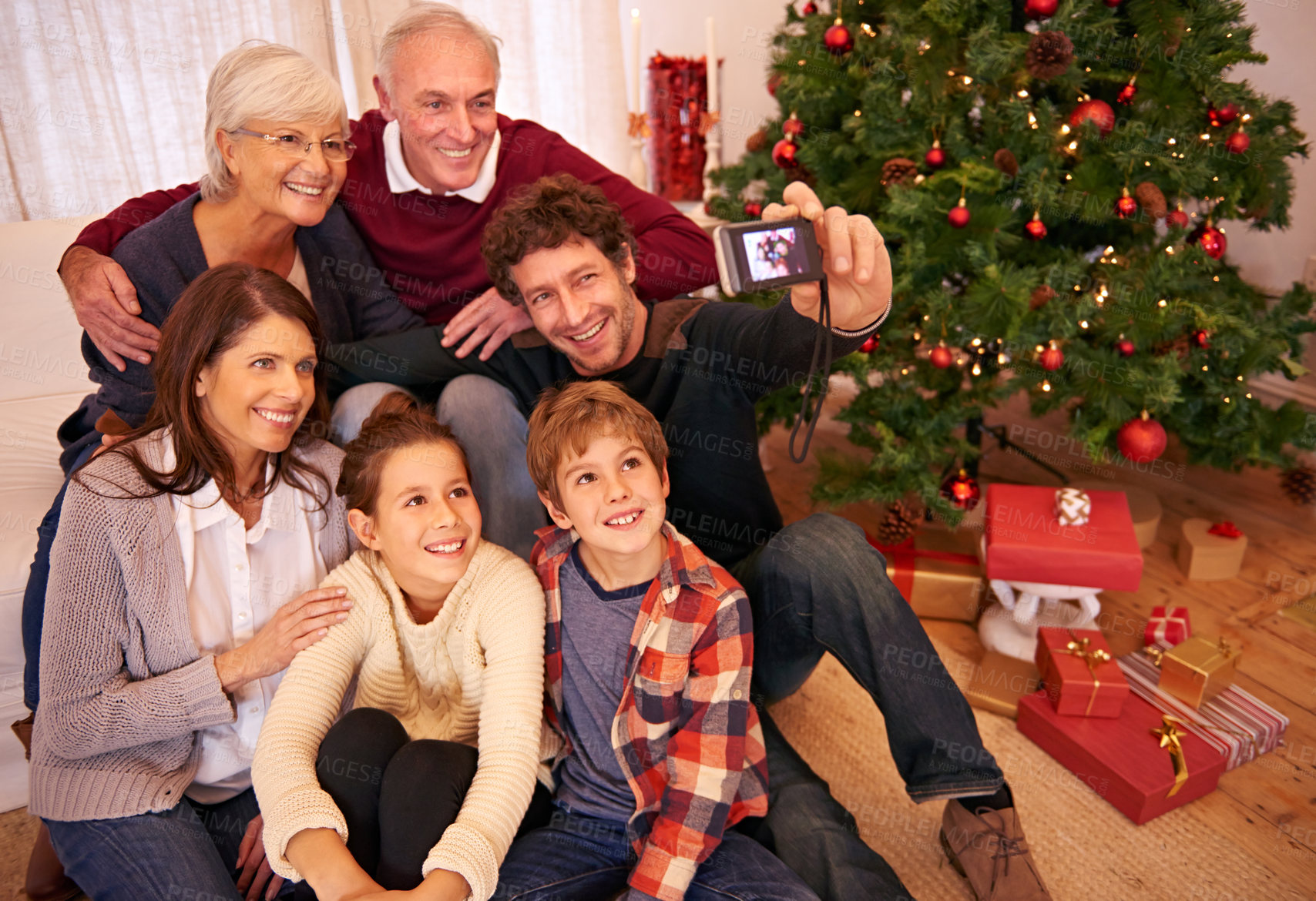 Buy stock photo Family, christmas party and phone selfie, festive season or holiday celebration. Portrait, smile and grandparents, kids and parents celebrate, picture pose or photo smile for memory together in home