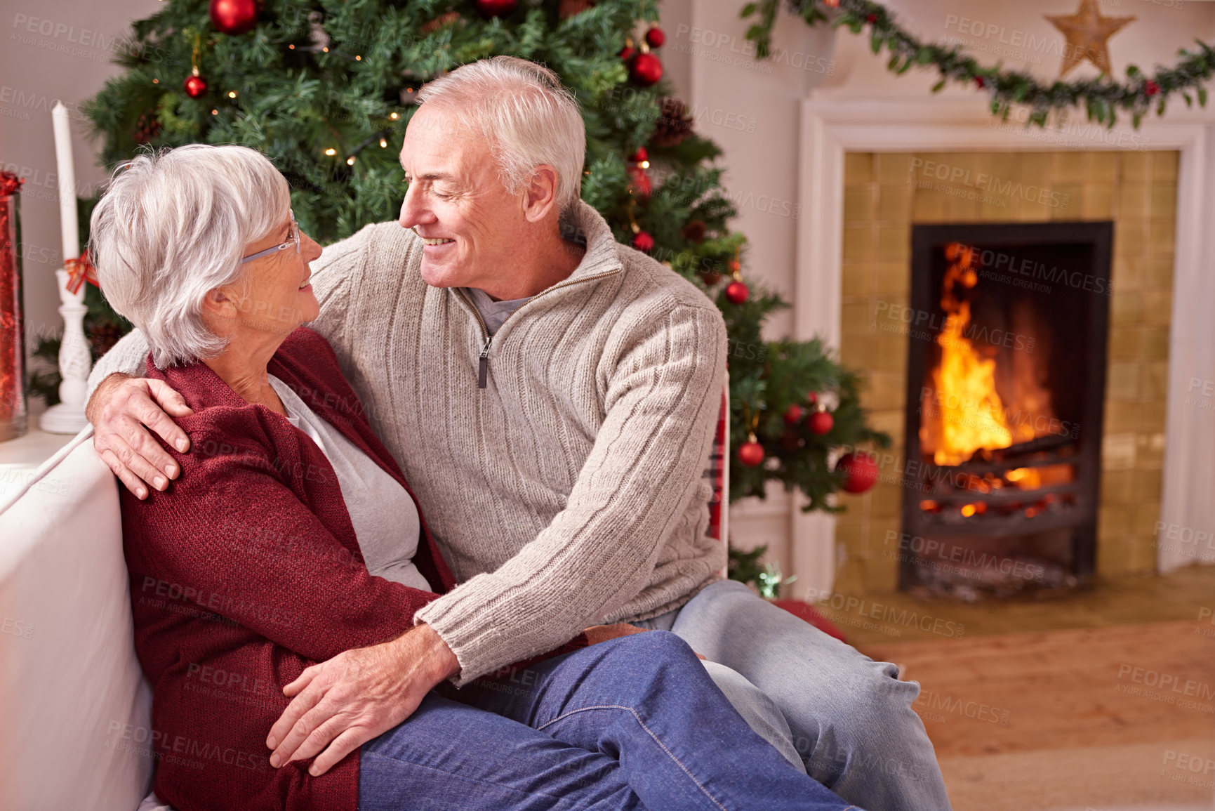 Buy stock photo Senior couple, christmas and relax on sofa together for romance, love or festive holiday celebration in home. Elderly man, woman and happy quality time on couch to celebrate with christmas tree
