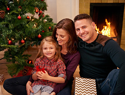 Buy stock photo Christmas, family with girl and happiness for celebration, peace or enjoy festive season together. Xmas, parents and mother with father, daughter and relax in living room with smile, bonding and love