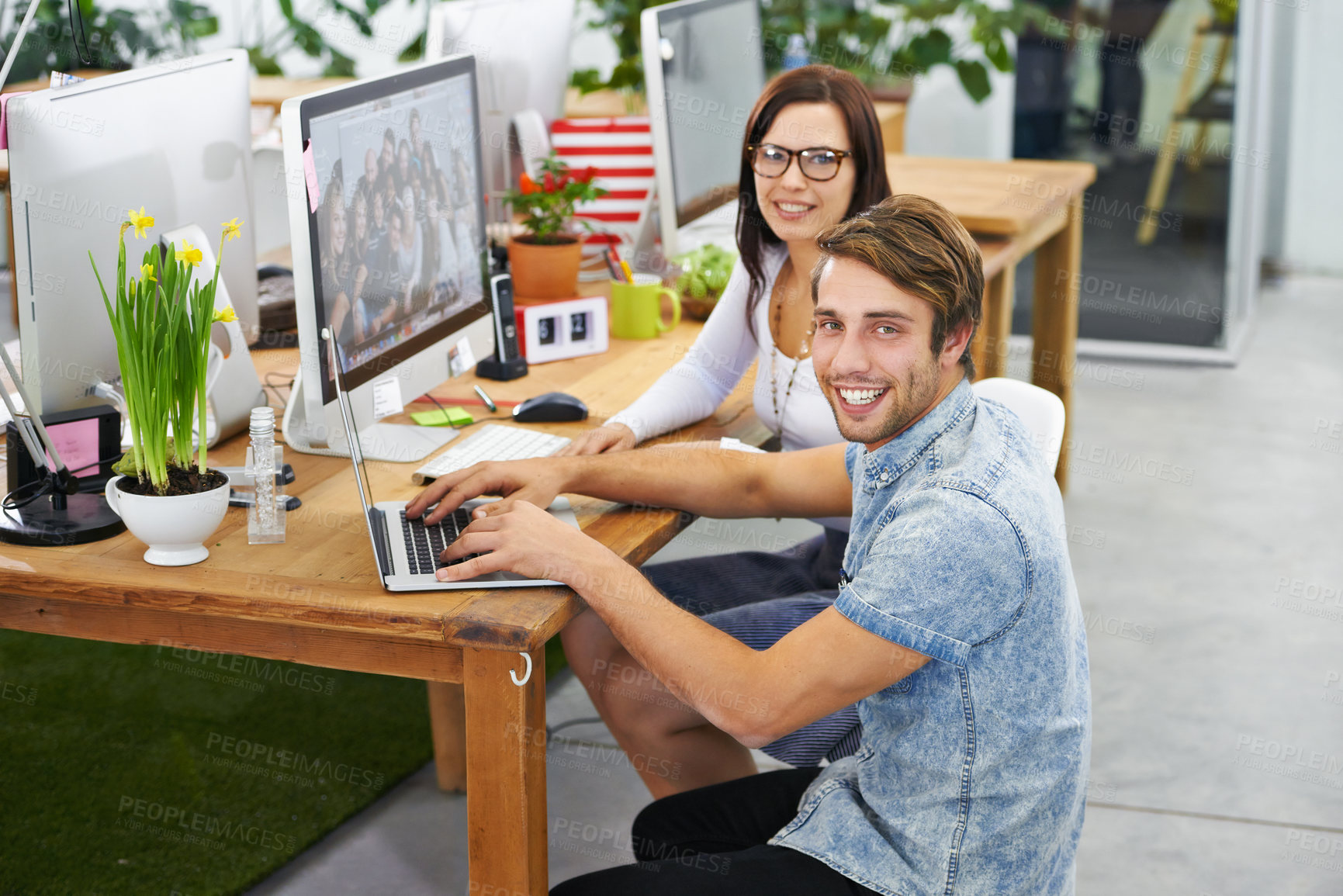 Buy stock photo Collaboration, man and woman with laptop, portrait and monitor on desk, technology and internet. Employees, staff and colleagues with smile for project, happiness and teamwork for creative design