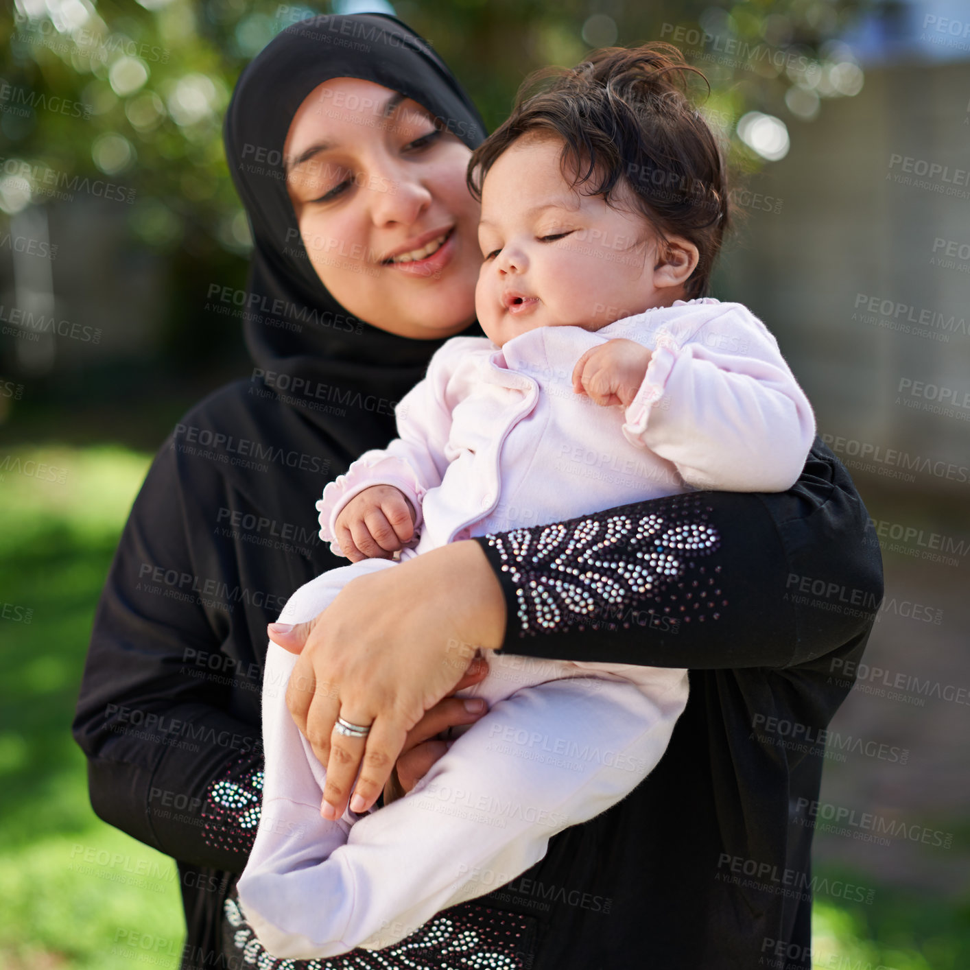 Buy stock photo Muslim, woman and baby cuddle outdoor, happy in garden with mother and child for Eid celebration. Motherhood, family and Islamic holiday with hijab, infant and hug with smile in backyard for bonding