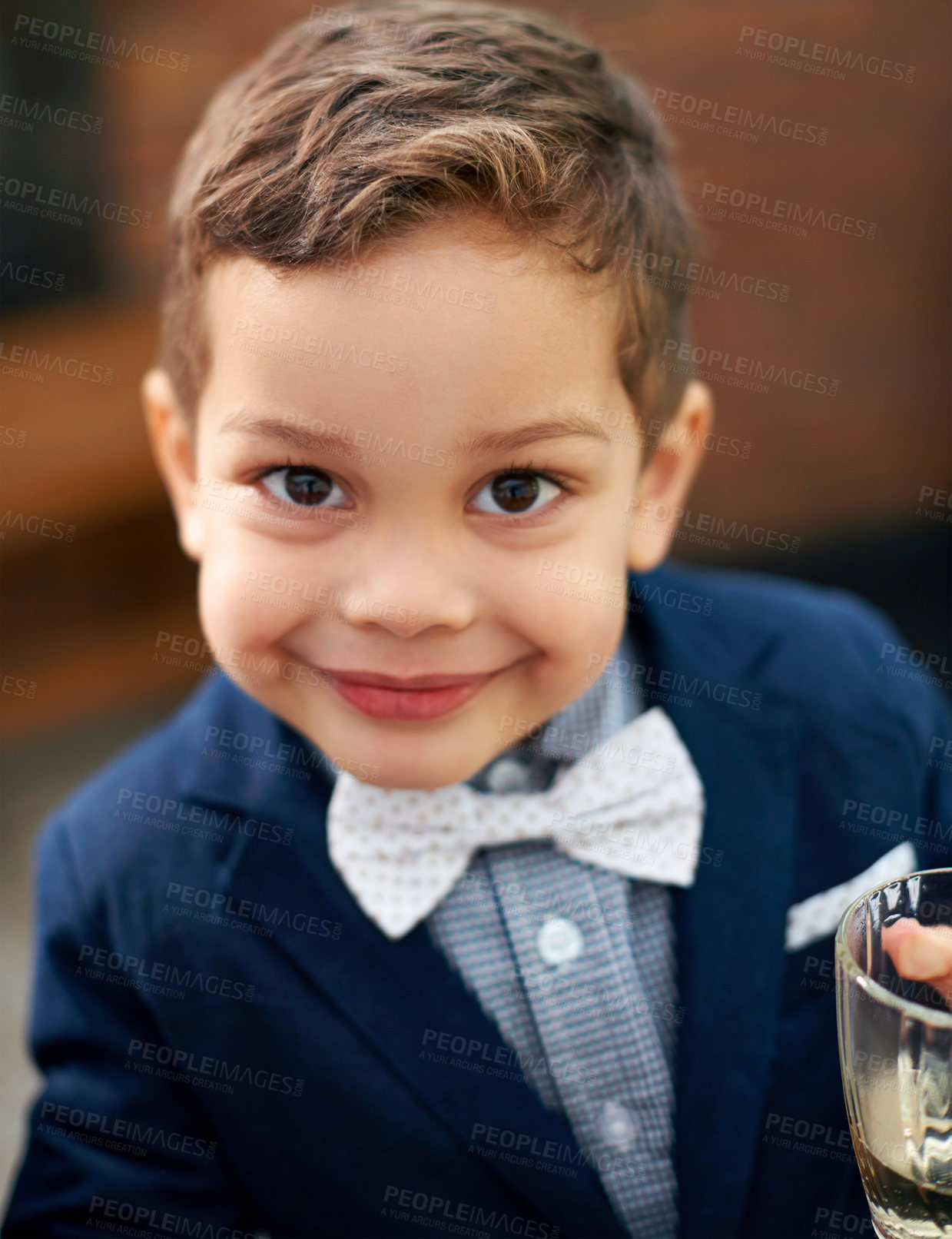Buy stock photo Young, child and portrait with bowtie, suit and smile for fashion, style and classic in outdoor. Cute, boy and outfit as gentleman, growth and development in childhood, fun and playful for event 