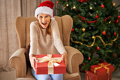 Buy stock photo Sofa, surprise and portrait of woman with gift for Christmas, celebration and religious holiday at home in living room. Female person, lady and smile for xmas present in house, apartment and lounge
