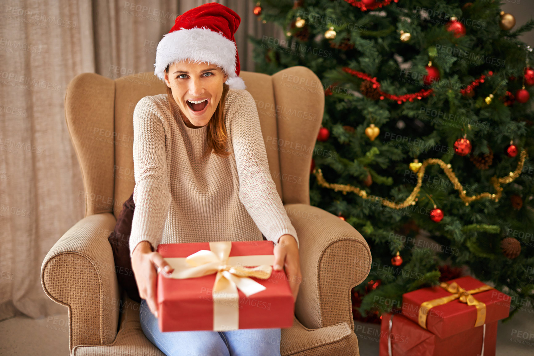 Buy stock photo Sofa, surprise and portrait of woman with gift for Christmas, celebration and religious holiday at home in living room. Female person, lady and smile for xmas present in house, apartment and lounge
