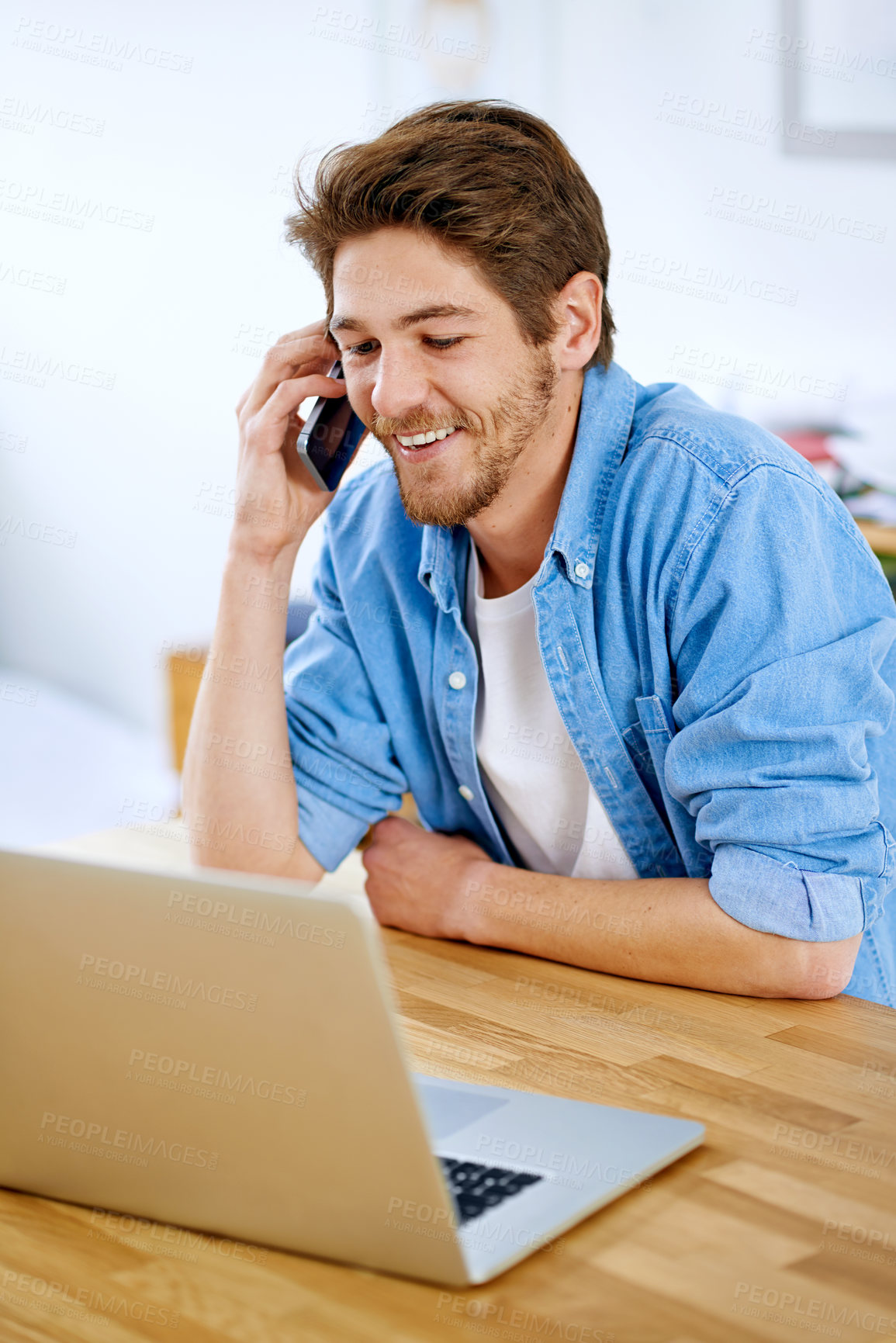 Buy stock photo Shot of a young entrepreneur talking on a phone