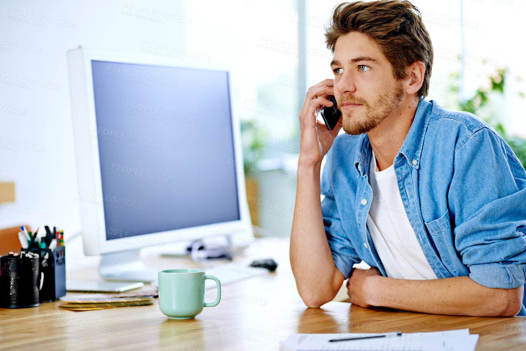 Buy stock photo Shot of a young entrepreneur talking on a cellphone