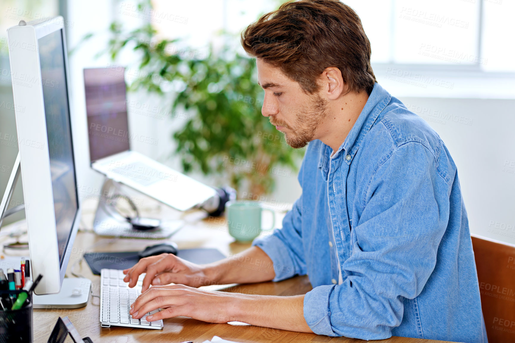 Buy stock photo Office, employee and man with keyboard, computer and technology for job, networking and internet. Creative, male person and staff for remote, working and happiness for career as author on desk