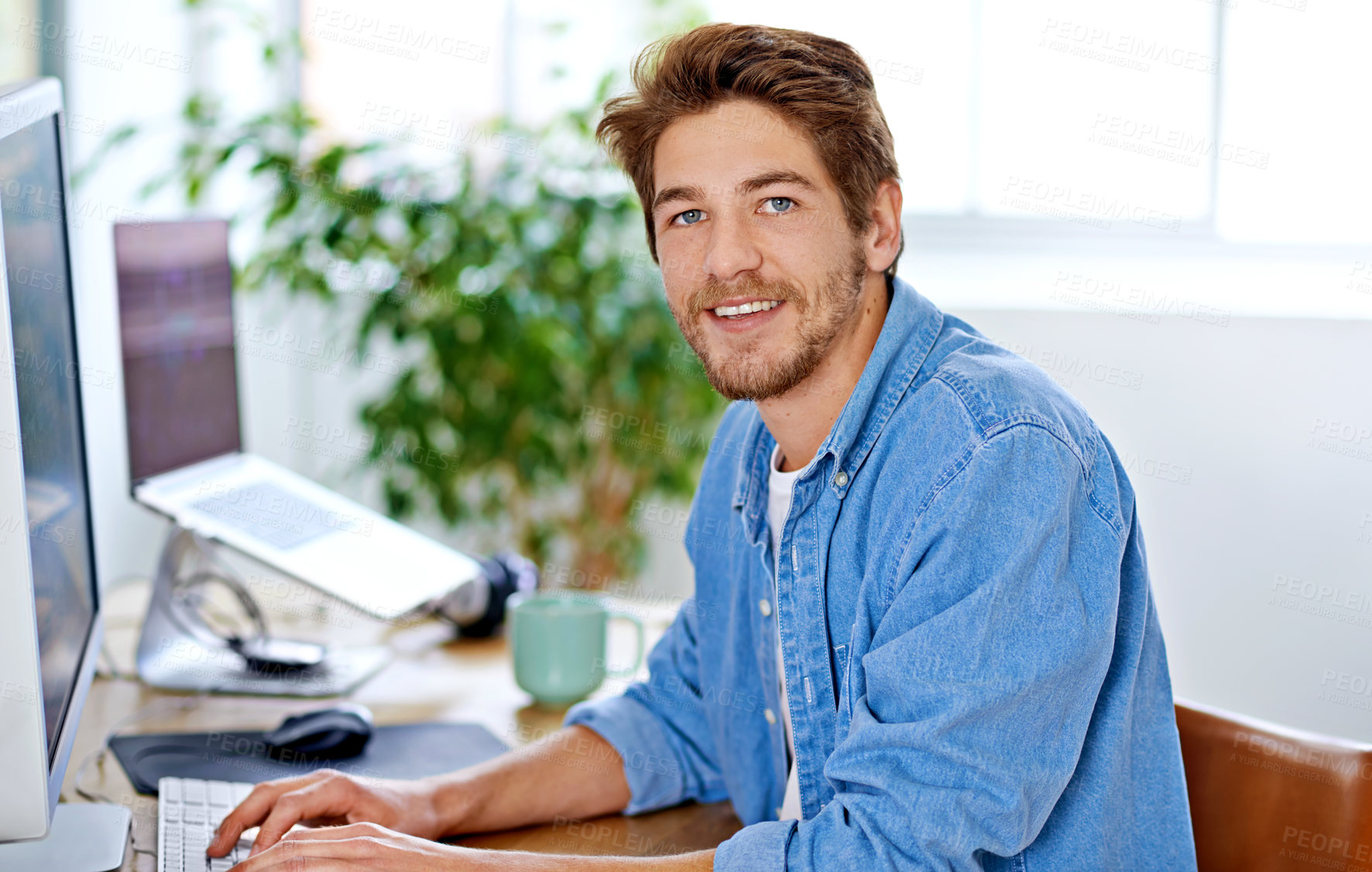 Buy stock photo Shot of a young man working in a home office