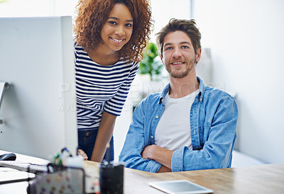 Buy stock photo Cropped shot of two colleagues working in their office