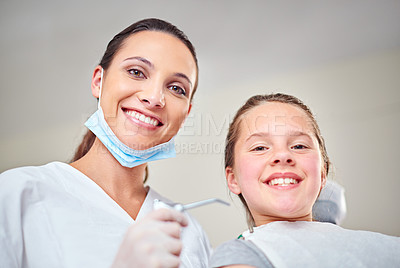 Buy stock photo Portrait of a female dentist standing beside her child patient