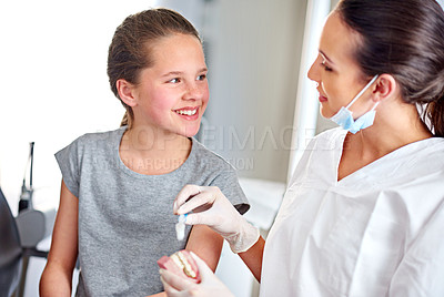Buy stock photo Dentist, advice and girl in office with teeth for consultation, appointment or checkup with smile. Female, doctor and child with toothbrush hygiene or teaching for help, dental care and consulting
