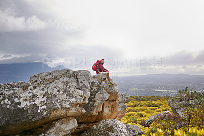 Buy stock photo Man, cliff and relax on outdoor hike in nature, mountain and peace or calm on rocks for wellness. Male person, exercise and travel with backpack on vacation, adventure and explore bush for fitness