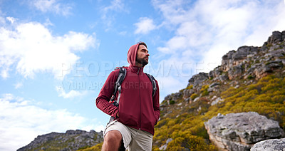 Buy stock photo Man, hiking and backpack in outdoor nature, mountain and peace or calm on rocks for wellness. Male person, exercise and travel on weekend vacation, adventure and explore for fitness or trekking
