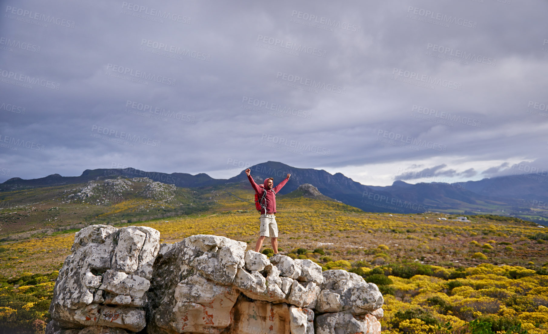 Buy stock photo Nature, mountain and man with celebration for hiking, peak and journey with success and freedom outdoor. Trekking, rock climbing and horizon with arms raised for achievement, travel and adventure