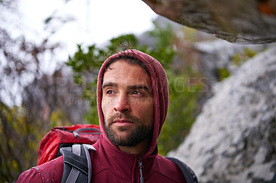 Buy stock photo Nature, serious and man on rock, backpack and thinking in mountain or stone for adventure. Hiking, earth and male person with climbing for travel, wellness and environment for outdoor bouldering