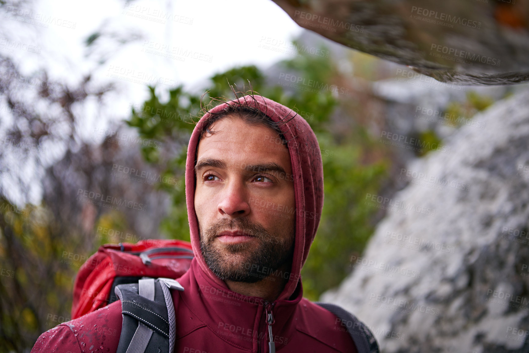 Buy stock photo Nature, serious and man on rock, backpack and thinking in mountain or stone for adventure. Hiking, earth and male person with climbing for travel, wellness and environment for outdoor bouldering