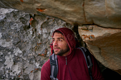 Buy stock photo Man, hiking adventure and rocks in cave with backpack for tough activity, nature and strong health. Male hiker, extreme survival and exercise for fitness with mountain, natural landscape and travel
