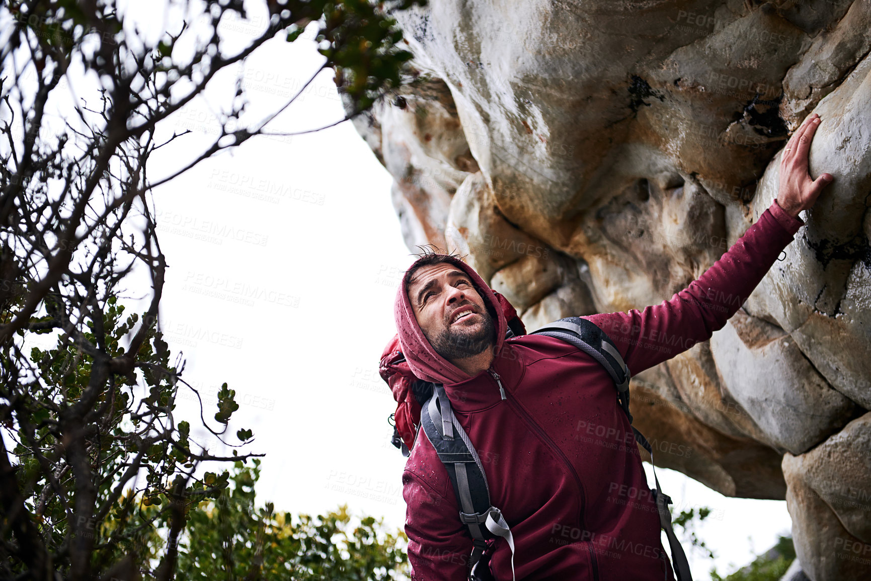 Buy stock photo Shot of a young man enjoying a hike through the mountains