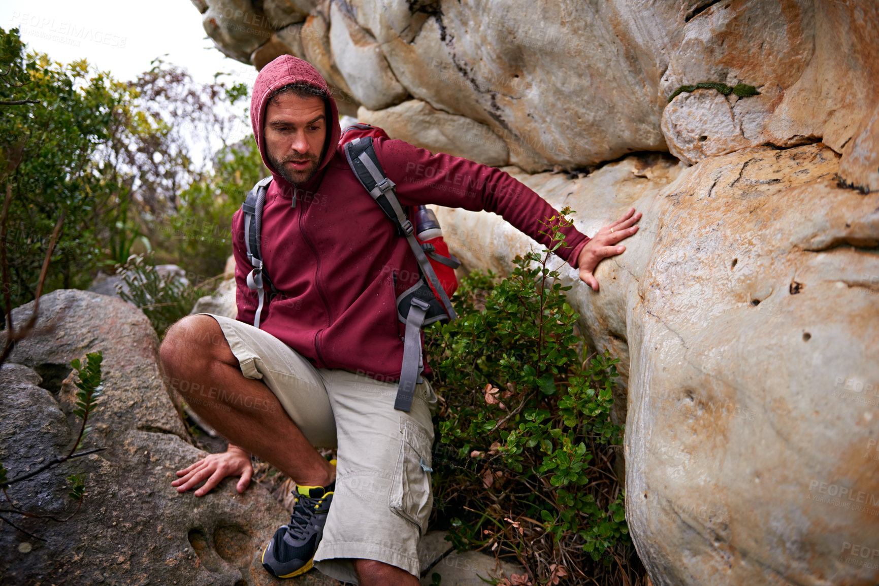 Buy stock photo Mountain, rock climbing and man hiking in nature with backpack for adventure for wellness in trip. Earth, fitness and male person in environment to relax, peace and gear on hill or cliff and land