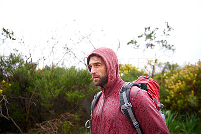 Buy stock photo Extreme, hiking and man in rain, walking and holiday for survival adventure, outdoor and trekking. Water, traveller and male person with backpack in tough environment, rough and destination of Europe