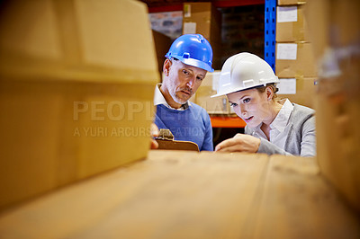 Buy stock photo Management, team and boxes for logistics inventory and distribution in warehouse, stock take and retail. Man, woman and wearing hardhats with clipboard for freight packaging in commercial factory.