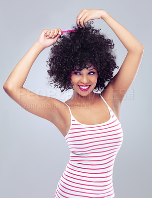 Buy stock photo Black woman, smile and afro in studio alone for haircare with comb, elegant and stylish. Girl, happy and confident with natural curl texture for cosmetics, beauty and fashion grey background