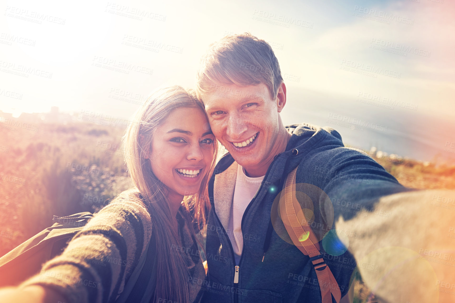 Buy stock photo Hiking, selfie and couple hug in nature with love, trust and bonding outdoor together. Backpack, travel or people portrait in countryside for adventure, vacation or romantic profile picture at sunset