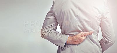 Buy stock photo Fingers crossed, hope and back of business in a studio with trust, prayer or wish for job promotion. Hand, suit and closeup of professional male person with good luck gesture by gray background.