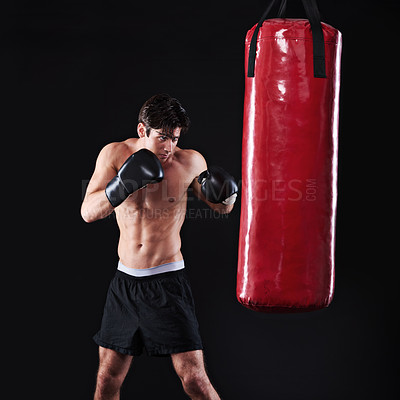 Buy stock photo Man, punch and boxing bag in studio for exercise practice or cardio workout for health, fighter or black background. Male person, gloves and martial arts training on mockup space, performance or fit