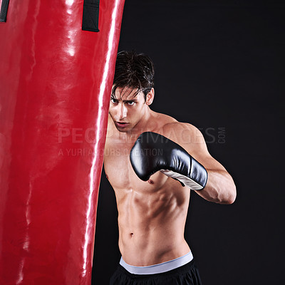 Buy stock photo Man, punching bag and challenge with fitness, training and fighter with gloves and wellness with cardio. Boxer, practice and athlete with exercise, gym or workout with endurance on a black background