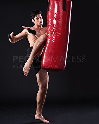 Buy stock photo Kickboxing, bag and man with training, fitness and exercise on a dark studio background. Healthy person, mockup space and model with endurance and practice with workout and wellness with challenge