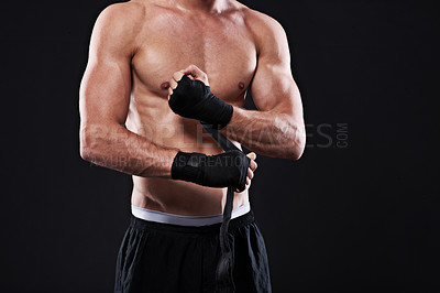 Buy stock photo Wrapping, hands and man in martial arts for boxing on black background in studio with preparation closeup. Tape, fist and ready to start training as boxer in mma or gym with fitness and mockup space